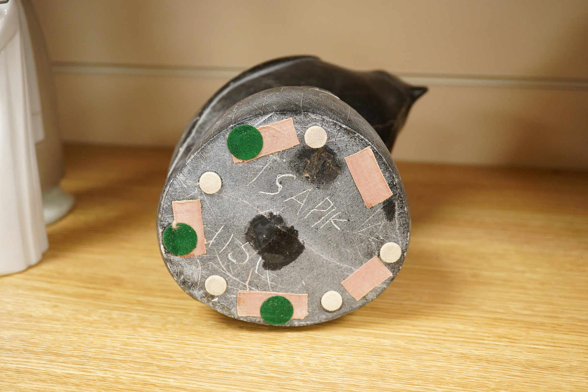 An Inuit stone carving of a falcon by Isapik, 18cm high